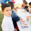 portrait good looking hispanic preschool student eating healthy food his lunch break