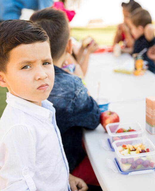portrait good looking hispanic preschool student eating healthy food his lunch break