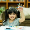 cheerful girl kid enjoy color painting with creativity ideas present messy hand home