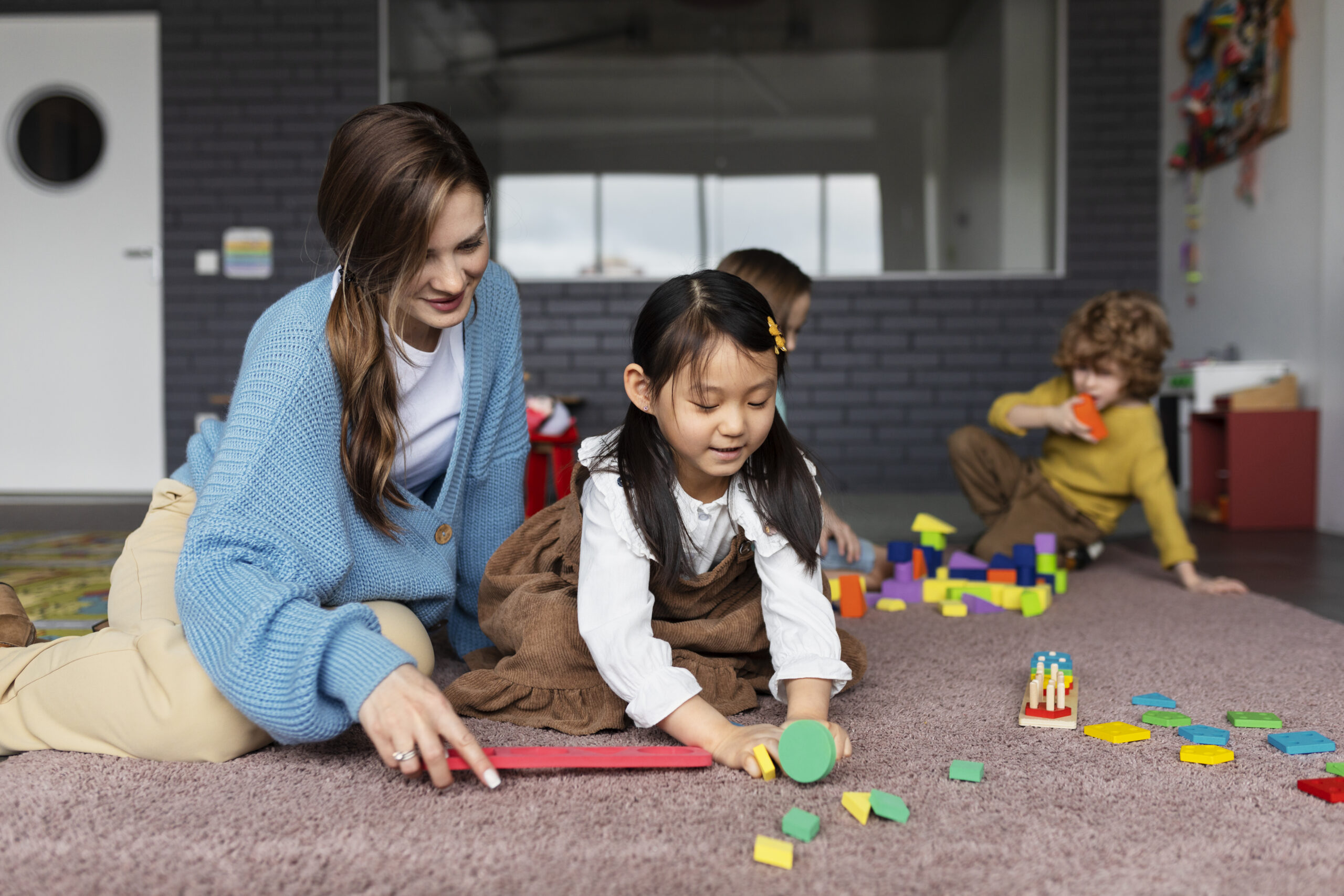 full shot smiley teacher helping girl learn scaled