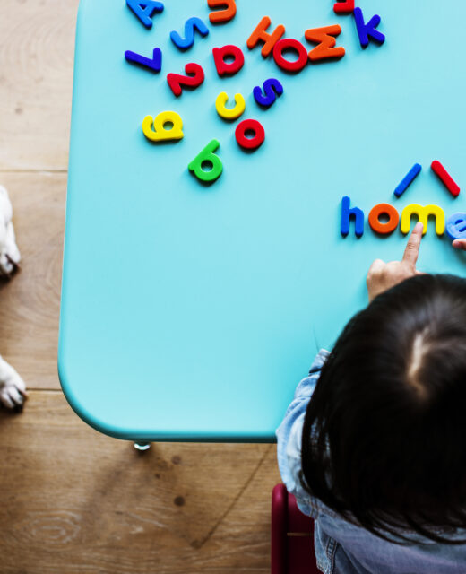 kid home playing with letters