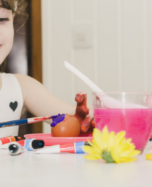 lovely girl painting egg with violet