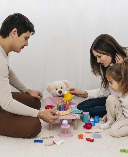 mother father playing with daughter home